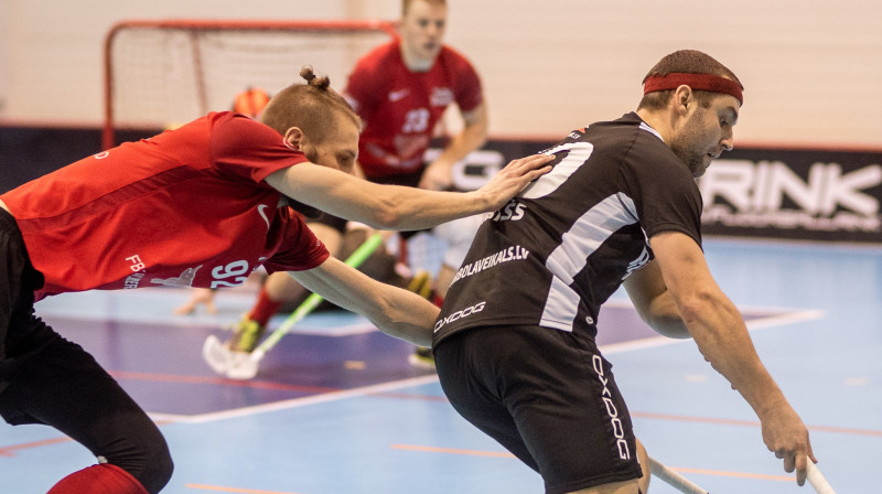 Valmierieši cenšas apturēt kocēnieti Reini Mirkšu. Foto: Raivo Sarelainens, floorball.lv